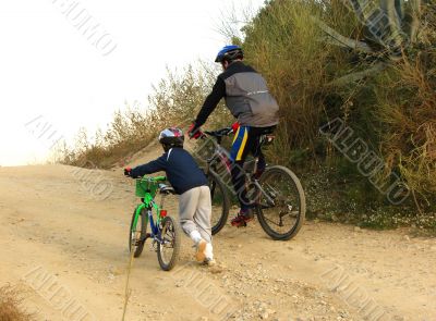 father and the son with bicycles
