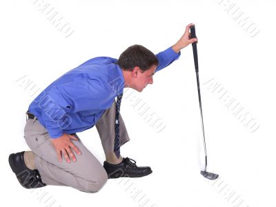 Man with blue shirt aiming over putter