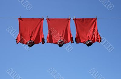 Laundry, three red t-shirts