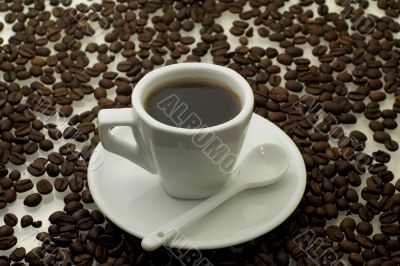 white cup of coffee with a coffee beans