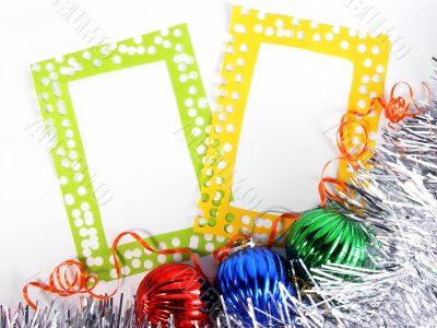 two photoframes with decorative balls and tinsel