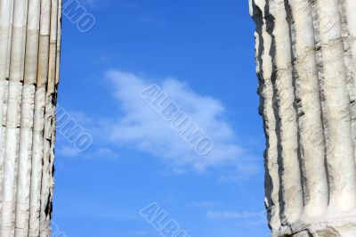 Blue clouded sky between two ancient Greek columns