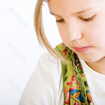 Head shot of a blond young girl looking down