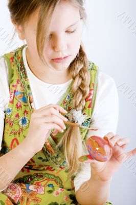Young girl painting eggs for oyster Young girl painting eggs for oyster
