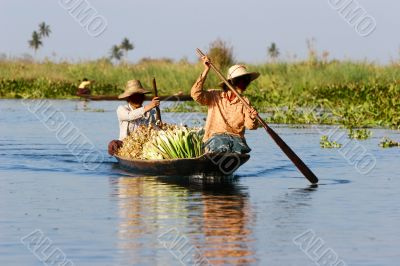 burmese women in wooden canoe