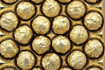 Chocolate sweets in golden foil