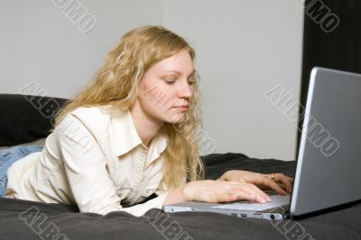 Woman on Bed with Laptop. Woman on Bed with Laptop.