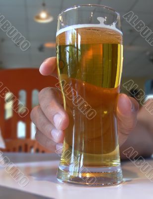 Hand holding a beer glass