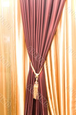 Purple velvet courtain with golden tassel