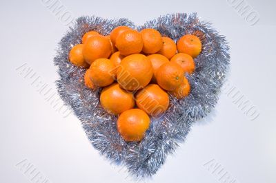 Heart made of citrus fruits. Present.