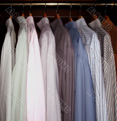 men`s dress shirts in wardrobe closet