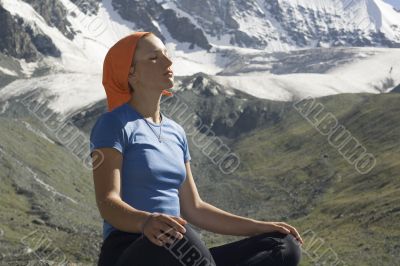 Meditating girl in the mountains 06