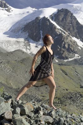 Girl in a black dress in the mountains