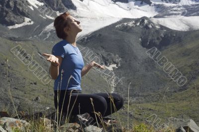 Meditating girl in the mountains 02
