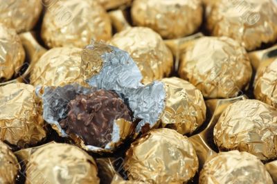 Chocolate sweets in golden foil