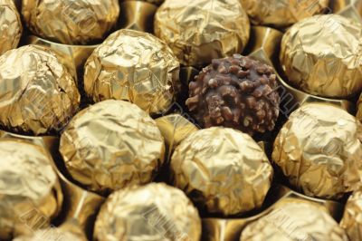 Chocolate sweets in golden foil