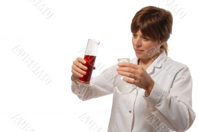 young lady scientist pours liquid