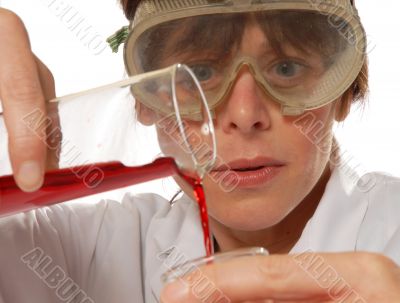 careful scientist / technician pouring liquid