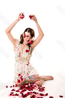 young girl tossing rose petal