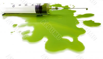 Syringe in a pool of a green liquid