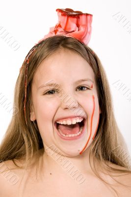 Blond child with desert on her head laughing