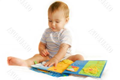 baby boy reading a book over white