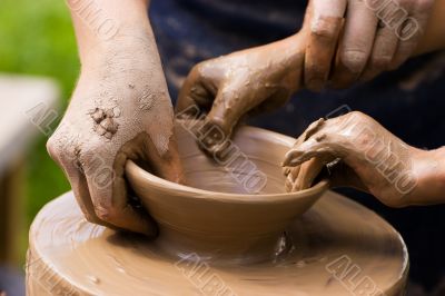 Potters and child hands