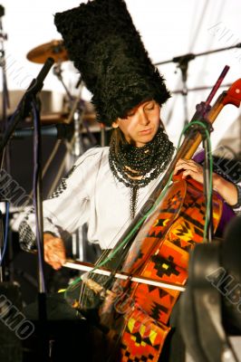 girl in traditional clothes playing violin