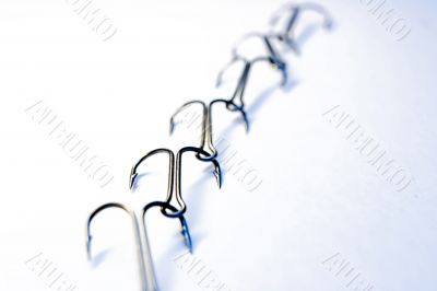 Chain from fishing hooks on a white background