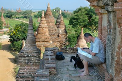 tourist reading map on temple background