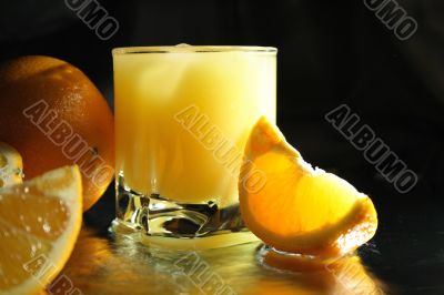 Full glass of orange juice with ice