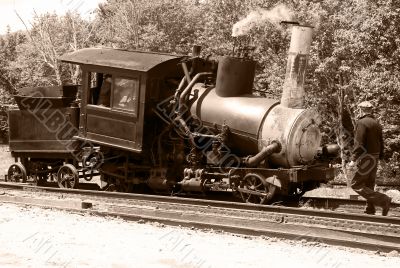 Antique steam train and railroad worker