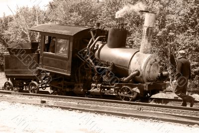 Antique steam train and railroad worker Antique steam train and railroad worker