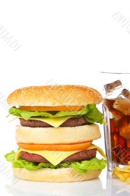 Double cheeseburger and soda glass