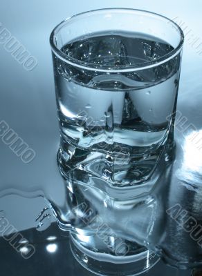 Glass of water in dark-blue