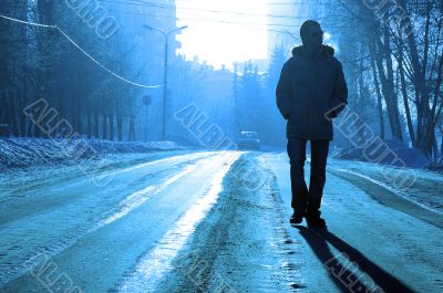 alone silhouette on the winter road