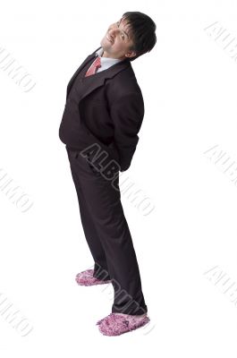 Funny young businessman put on pink slippers