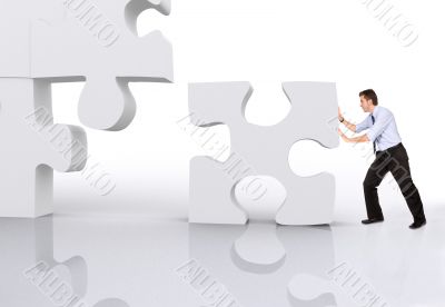 business man building a puzzle