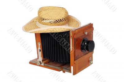Photo camera and straw hat