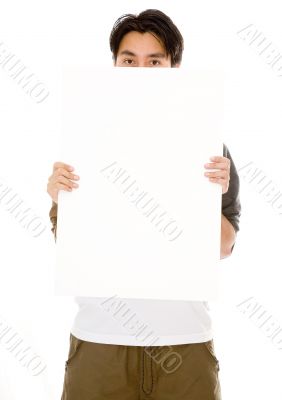 casual guy hiding behind a white board