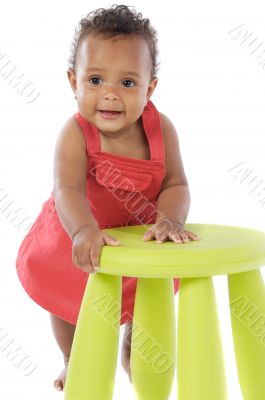 Toddler playing with a chair