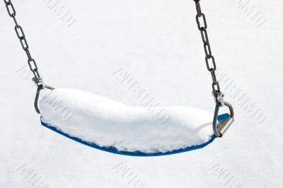 Playground swing in snow Playground swing in snow