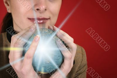 Globe in a girl`s hands