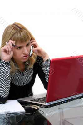 woman is thinking and calling by phone sitting near laptop