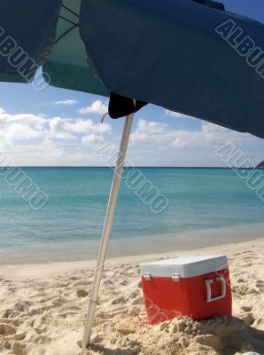 Box and umbrella on the beach