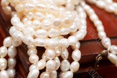 White real river pearls on wooden box