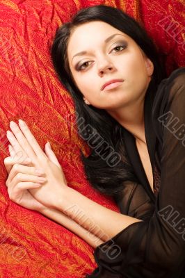 Beautiful girl lying on a bed. Portrait.