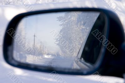 wood reflected in an automobile mirror