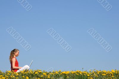 Nice girl working with laptop outdoors