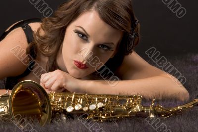 Woman portrait with saxophone in retro style